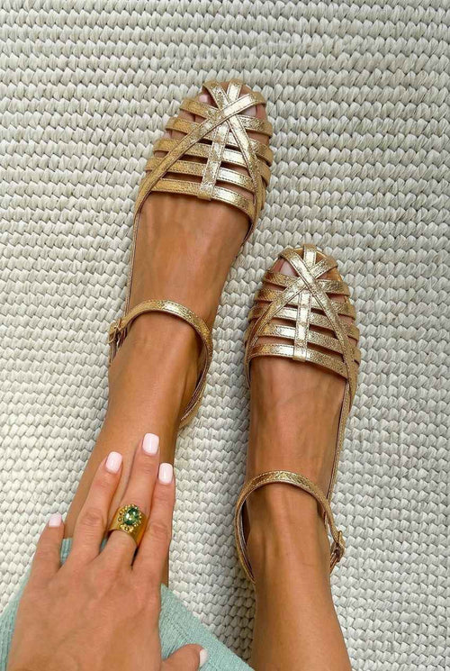 Flat closed-toe cage sandals with an ankle strap
