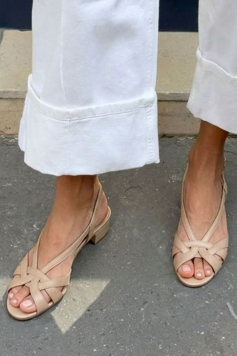 Nude leather slingback sandals with crisscross straps and a low heel