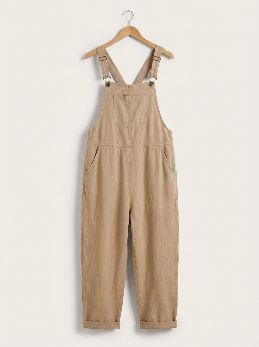 Beige linen dungarees on a wooden hanger