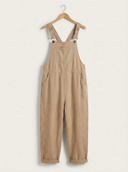 Beige linen dungarees on a wooden hanger