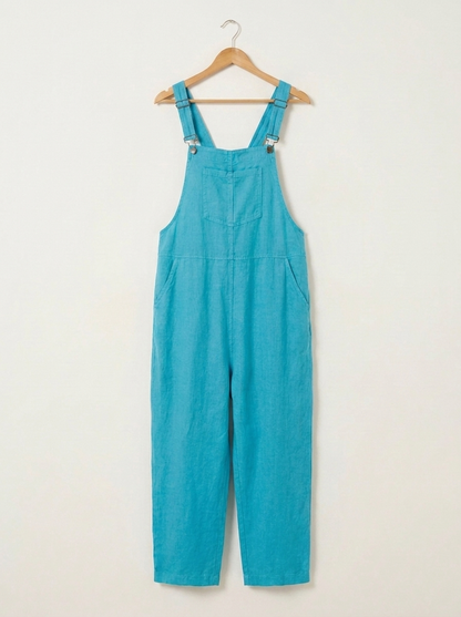Turquoise linen dungarees on a wooden hanger